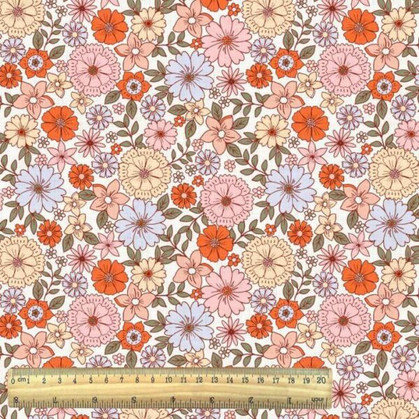orange tones mod small flowers on white cotton woven fabric with ruler
