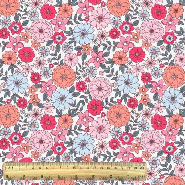 pink tones mod small flowers on white cotton woven fabric with ruler