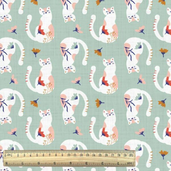 chadwick tacha cats print on soft sage green woven fabric with ruler