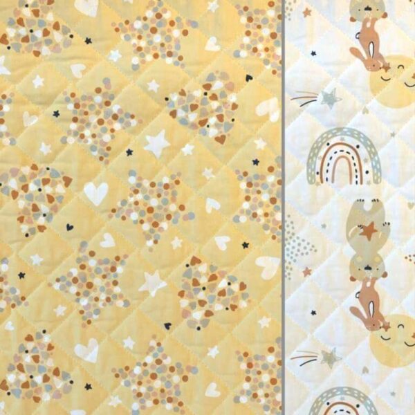 Quilted double sided cotton fabric in a sweet yellow children's nursery design