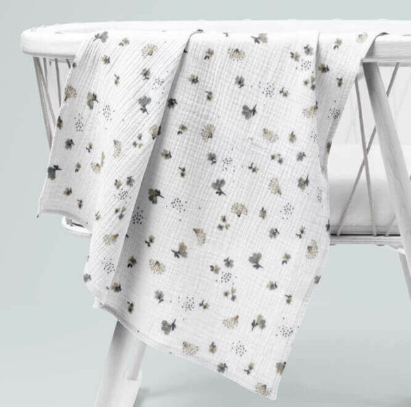 double gauze blanket in Nelsi draped over a childs cot