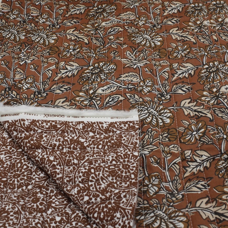 Quilted double sided cotton fabric in an elegant indienne brown floral design